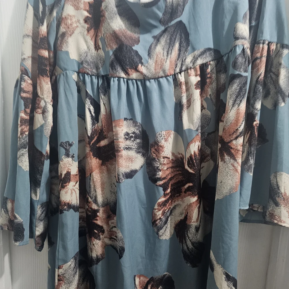 ￼

This is an Altar'd State Blue Floral Square Neck Tie Back Mini Dress - Picture 3 of 5